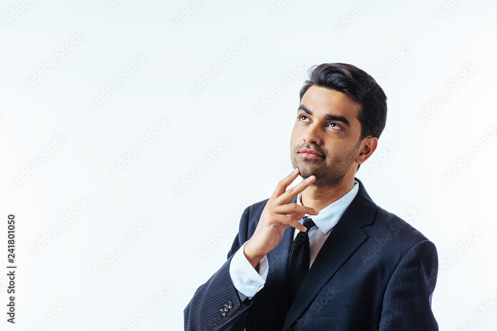 Portrait of a good looking businessman with one finger on his chin. isolated on white background Portrait of a good looking businessman with one finger on his chin. isolated on white background