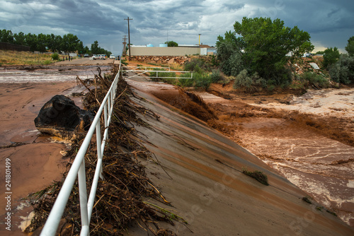 Muddy flash flood running through culverts in rural desert town