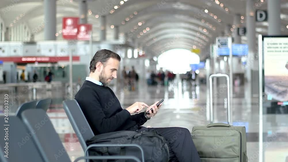Businessman using mobile at the airport Businessman using mobile at the airport