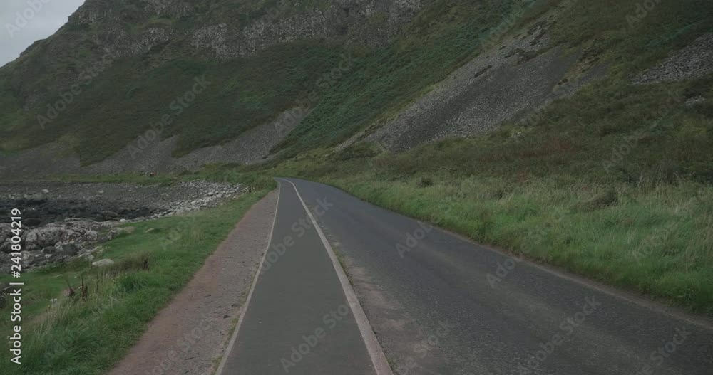hand hold shoot waking on the countryside road in Northern coastline,Giant causeway,Northern Ireland hand hold shoot waking on the countryside road in Northern coastline,Giant causeway,Northern Ireland