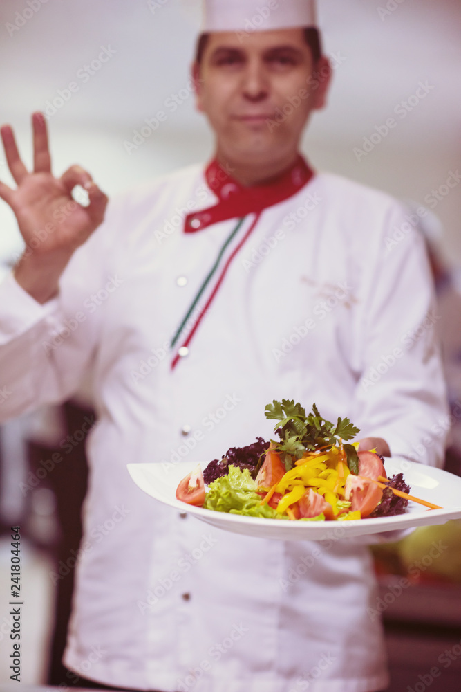 Chef showing a plate of tasty meal Chef showing a plate of tasty meal