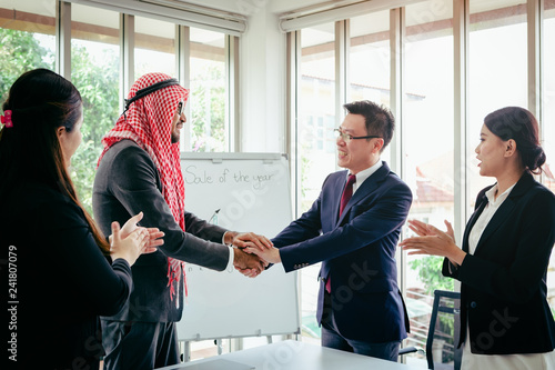 Business meeting Asian team and Arabic man presenting his ideas in office room