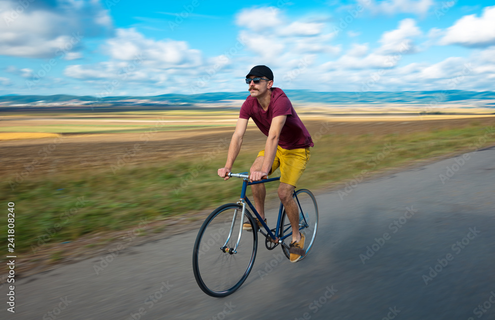 Natural view with cyclist going somewhere with stylish bike Natural view with cyclist going somewhere with stylish bike