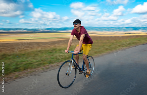 Natural view with cyclist going somewhere with stylish bike