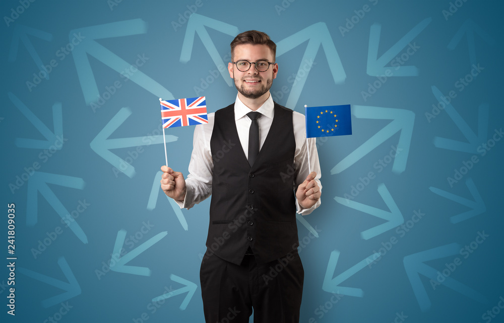 Cheerful elegant boy standing with flag on his hand and chalk drawn arrows around Cheerful elegant boy standing with flag on his hand and chalk drawn arrows around