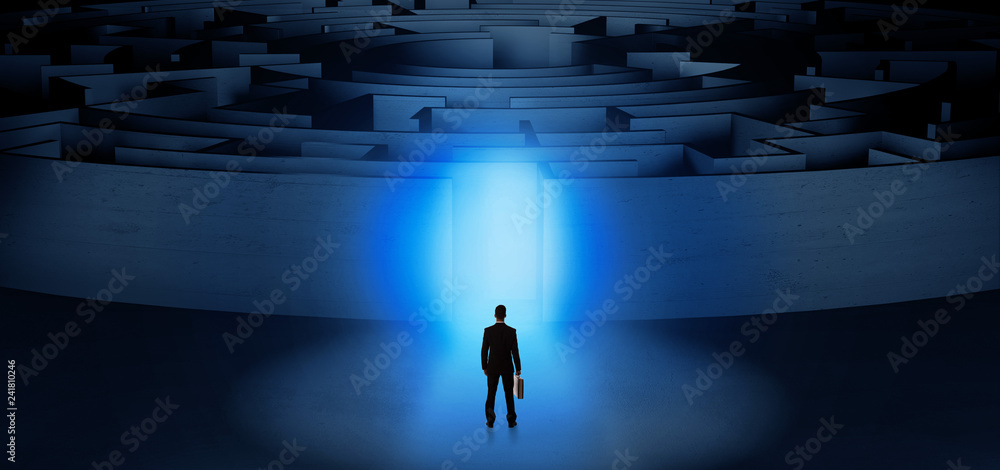 Businessman getting ready to enter a concentric labyrinth with lighted entrance concept
Businessman getting ready to enter a concentric labyrinth with lighted entrance concept