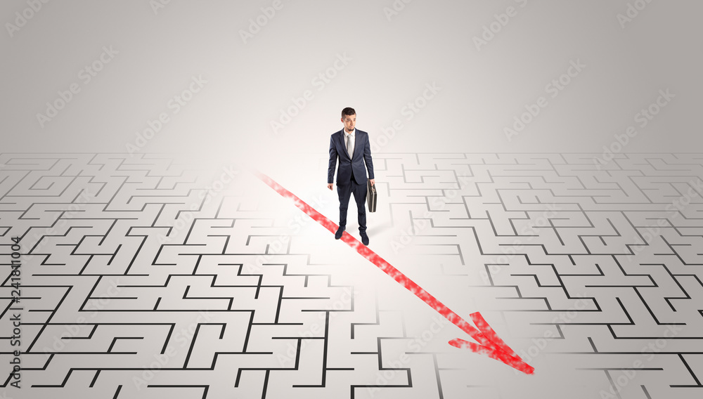Businessman going through the maze with red arrow
Businessman going through the maze with red arrow