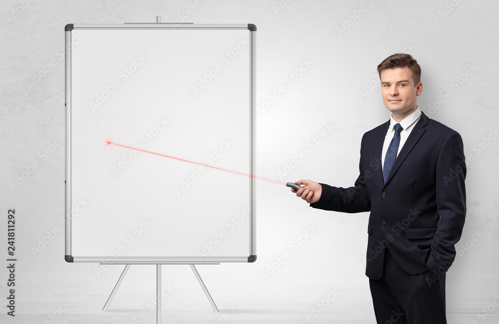 Young businessman with laser pointer and copyspace white blackboard Young businessman with laser pointer and copyspace white blackboard