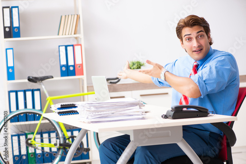 Young businessman using bike to commute to the office