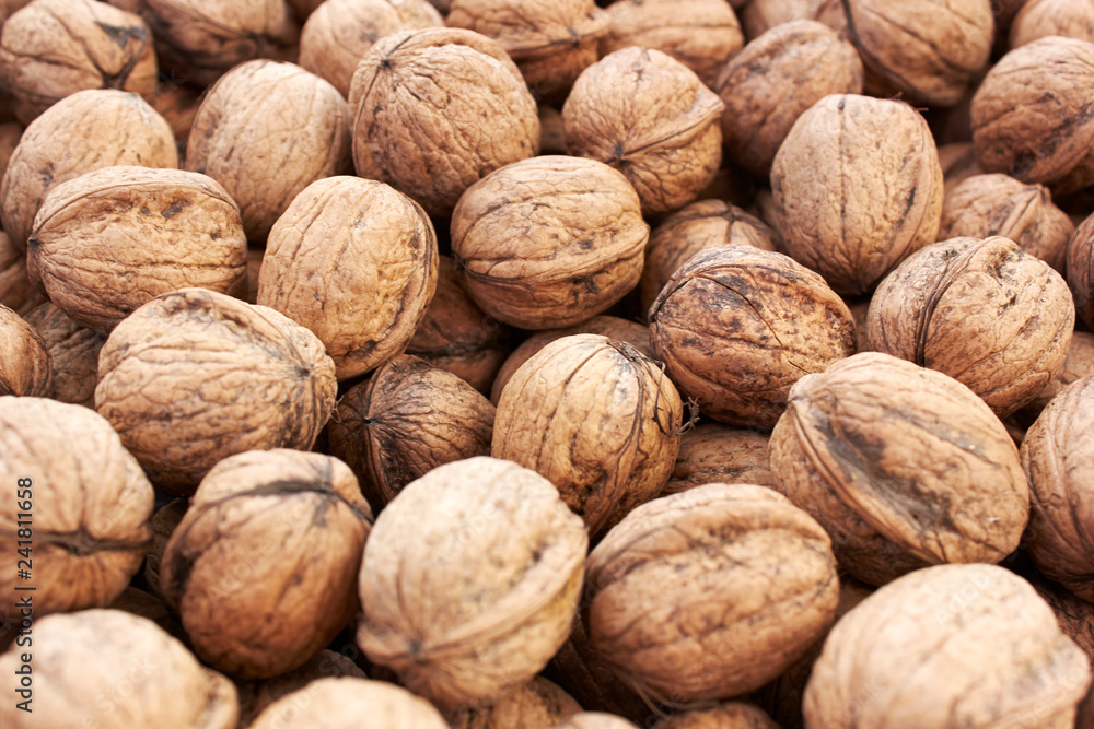 closeup of walnuts on wooden background closeup of walnuts on wooden background