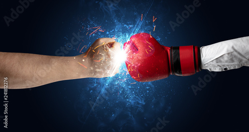 Two hands fighting with light, glow, spark and smoke concept  © ra2 studio
