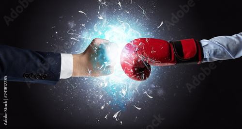 Two hands fighting and breaking glass into small pieces with blue light concept  © ra2 studio