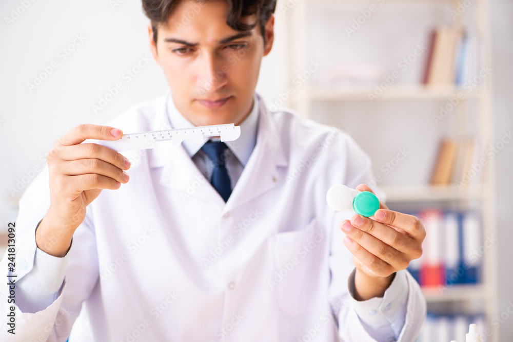 Young handsome doctor oculist working at the clinic Young handsome doctor oculist working at the clinic