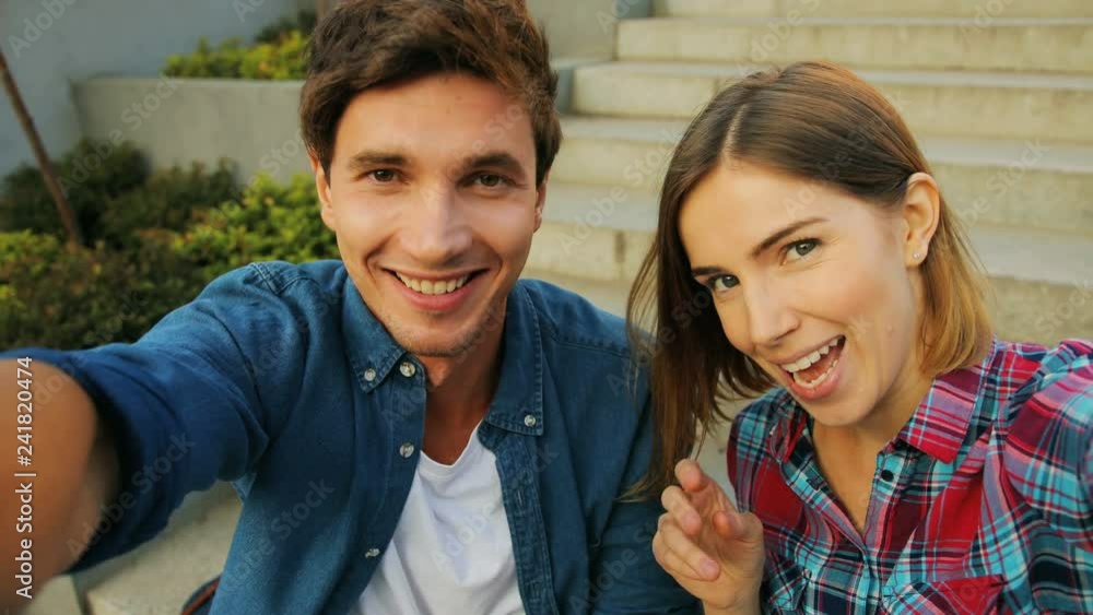 Happy young caucasian couple having video chat on holiday trip sharing summer adventures with friends. Happy young caucasian couple having video chat on holiday trip sharing summer adventures with friends.