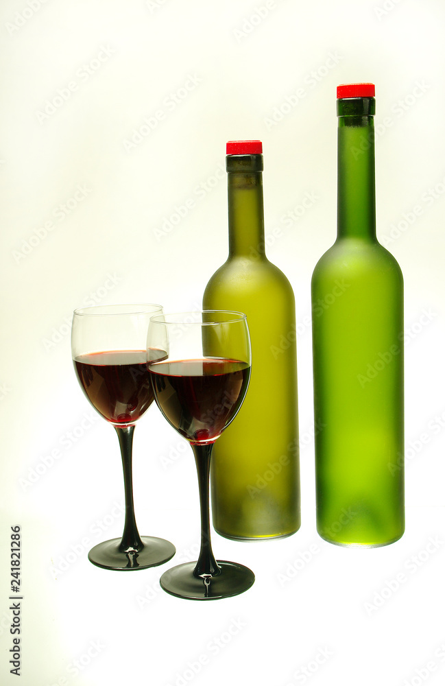 Two glasses of wine and two bottles Isolated on white Two glasses of wine and two bottles Isolated on white
