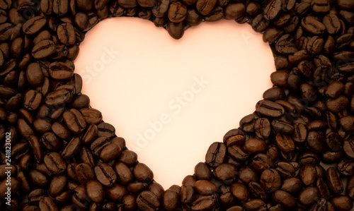 Heart shaped coffee beans on pink