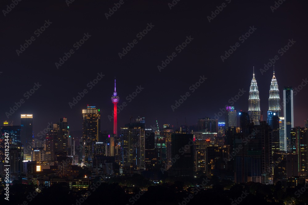 Night view of downtown Kuala Lumpur, a capital of Malaysia. Its modern skyline is dominated by the 451m-tall Petronas Twin Towers.