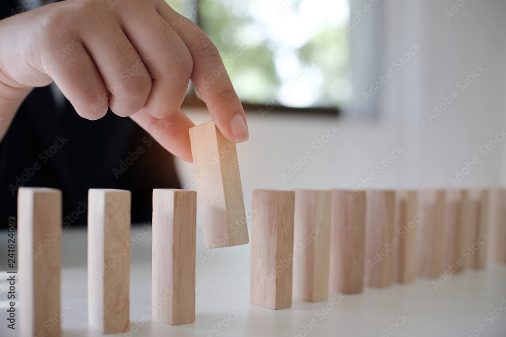 Planning risk and strategy in businessman gambling placing wooden block.Business concept for growth success process Planning risk and strategy in businessman gambling placing wooden block.Business concept for growth success process