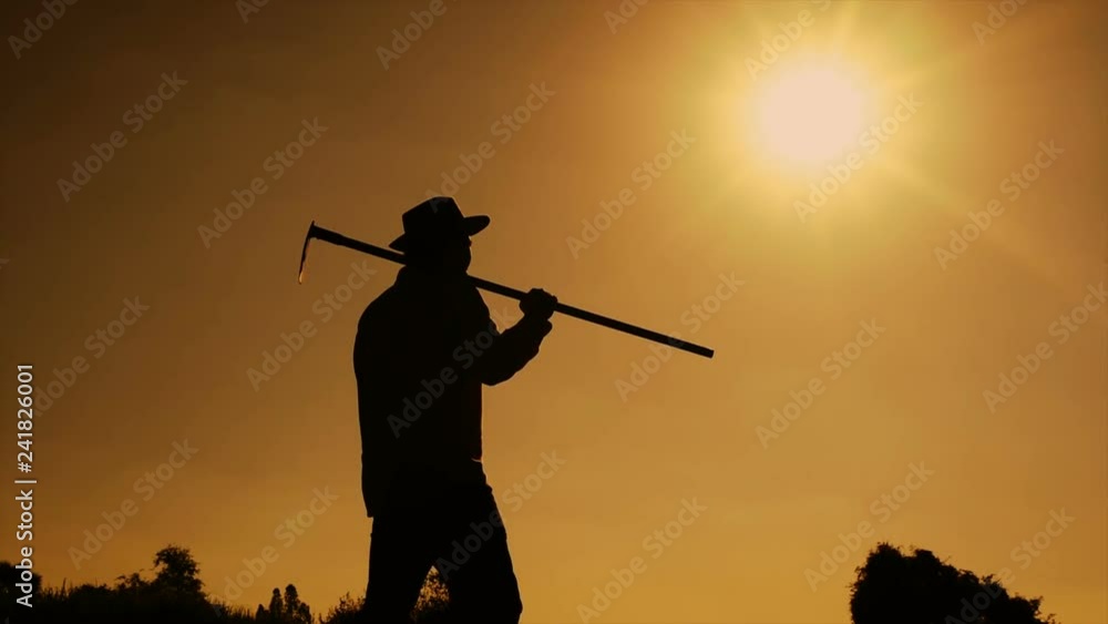 Agriculture life Concept : Black silhouette of a worker holding spade is digging soil at sunset light. Asian farmer holding spade and digging the soil. Agriculture life Concept : Black silhouette of a worker holding spade is digging soil at sunset light. Asian farmer holding spade and digging the soil.