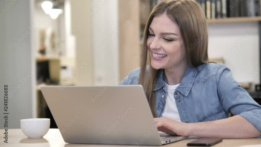 Creative Woman Celebrating Success while Working on Laptop Creative Woman Celebrating Success while Working on Laptop