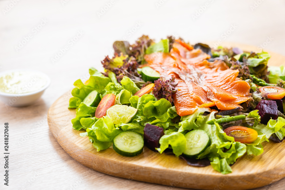 Raw Smoked salmon meat fish with fresh green vegetable salad Raw Smoked salmon meat fish with fresh green vegetable salad