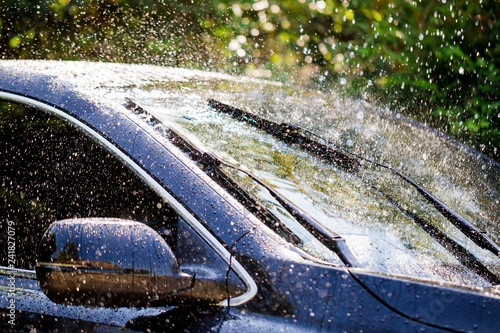 Car windshield with rain drops and frameless wiper blade