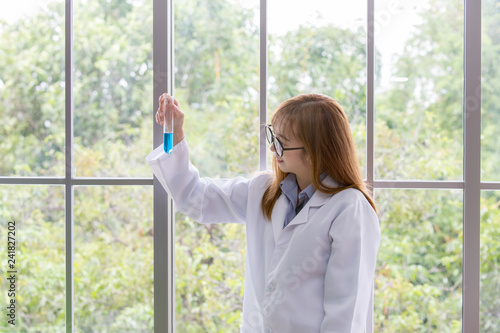 Science whit blue spirit mind. Scientific substance blue in on her hand at lab a background. Beautiful smiling female doctor or Scientist holding Scientific substance organic. asian people.