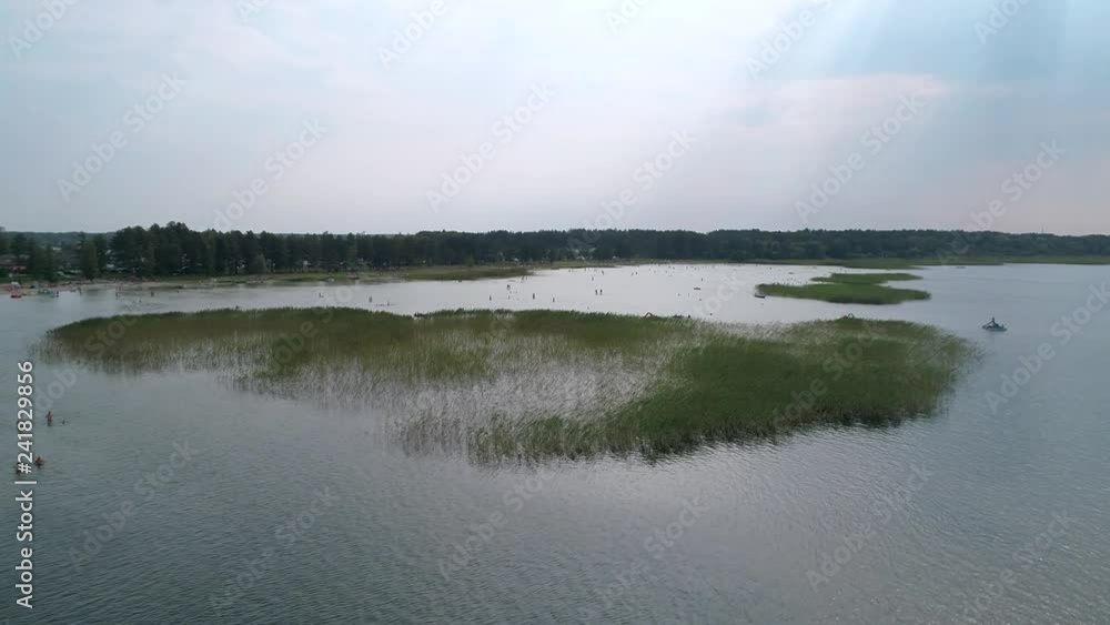 Aerial view of the lake Svityaz, people swimming, summer, slow motion Aerial view of the lake Svityaz, people swimming, summer, slow motion