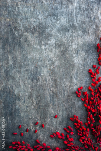 Bright barbery berries; red berberis on rusty wooden background photo