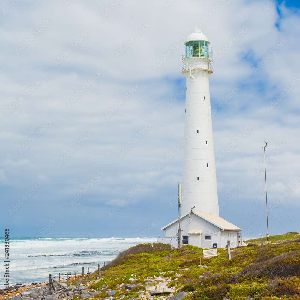 Lighthouse on a rugged coastline during the daytime