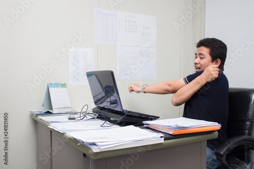 A man working in the office him serious and headache with burnout