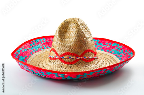 Cinco de mayo, traditional mexican hat and caribbean culture concept theme with close up on wicker or straw sombrero decorated in bright colors isolated on white background with a clipping path cutout