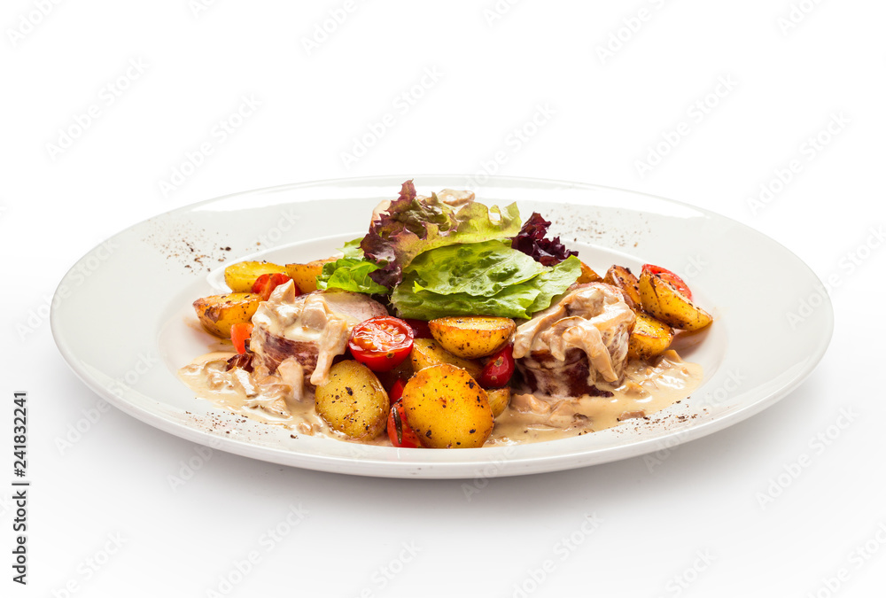 meat medallions in cream sauce with garnish of baked young potatoes meat medallions in cream sauce with garnish of baked young potatoes