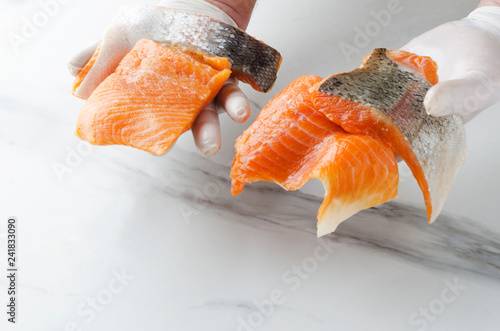 Man holding several pieces of fresh raw salmon.Tasty pieces of fish