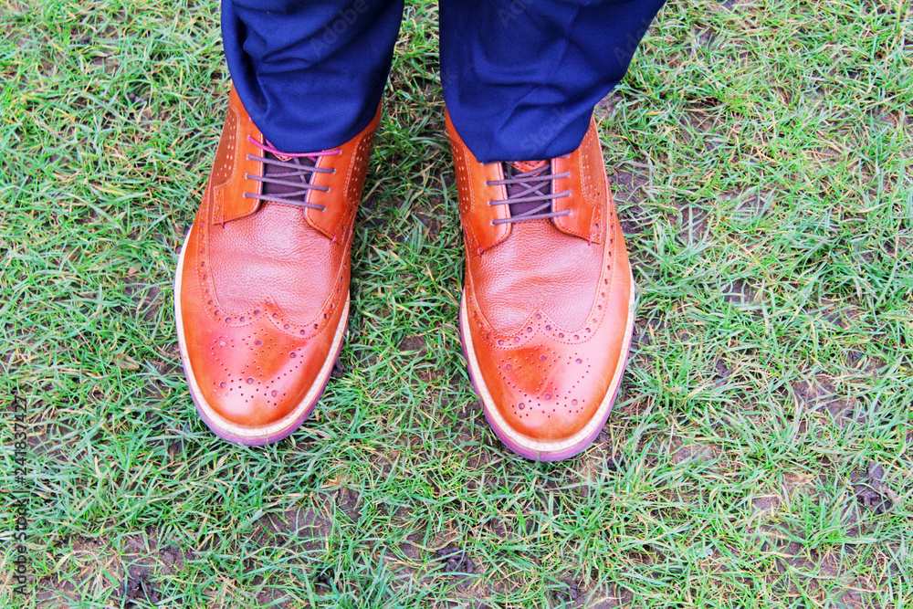 pair of shoes on green grass pair of shoes on green grass