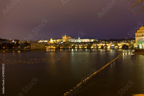 Night colorful snowy Christmas Prague Lesser Town with gothic Castle and Charles Bridge, Czech republic © Kajano