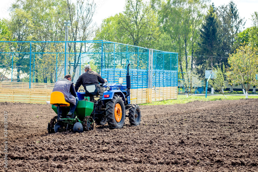 Planting potatoes with a tractor. Mechanization of agricultural work_ Planting potatoes with a tractor. Mechanization of agricultural work_