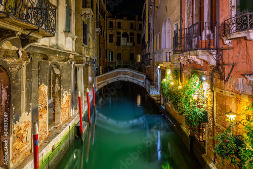 Narrow canal with bridge in Venice, Italy. Architecture and landmark of Venice. Night cozy cityscape of Venice.