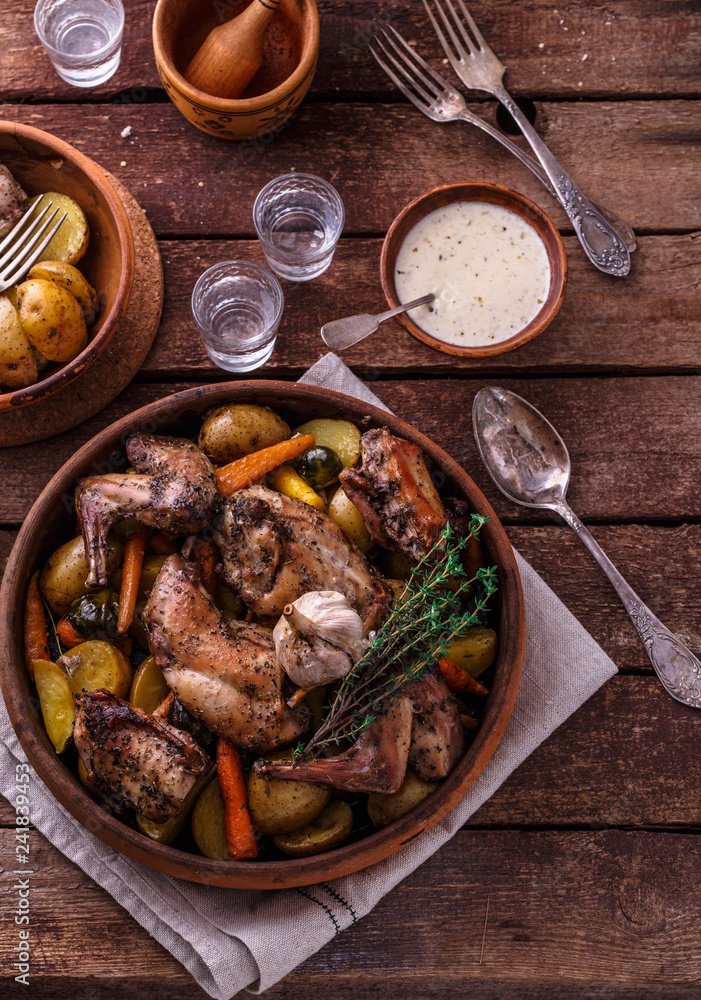 Oven baked rabbit with garlic sauce, copy space Oven baked rabbit with garlic sauce, copy space