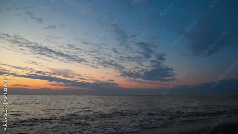 Sunset at sea. Dark blue sky and orange clouds on horizon. Sunset at sea. Dark blue sky and orange clouds on horizon.