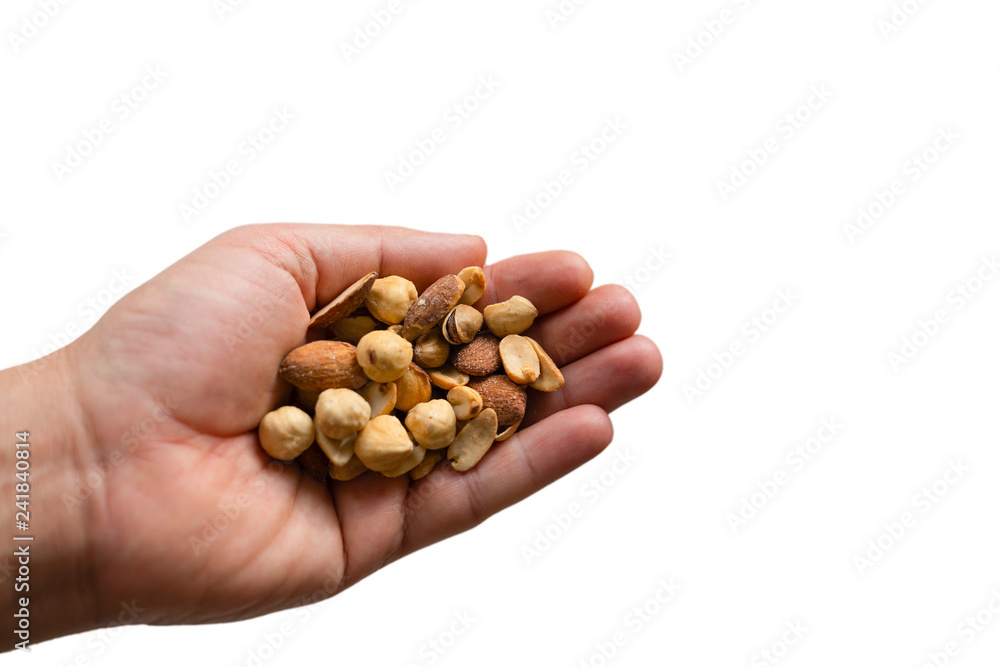 A hand holding a wide variety of nuts and seeds with isolated white backgrounds A hand holding a wide variety of nuts and seeds with isolated white backgrounds