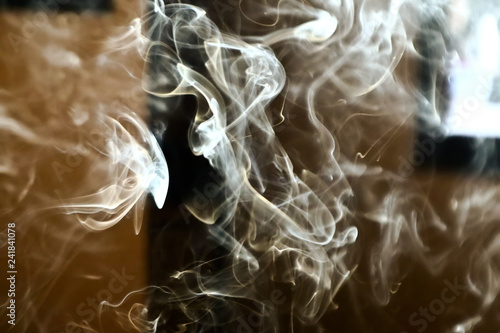 Smoke steam in room lighten by sun light, hazy steam curls for decorative special effect, abstract cigarette smoke background