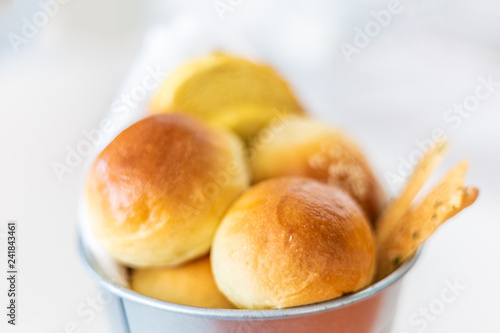 Rolls and various type of breads in silver bucket served at dinning table