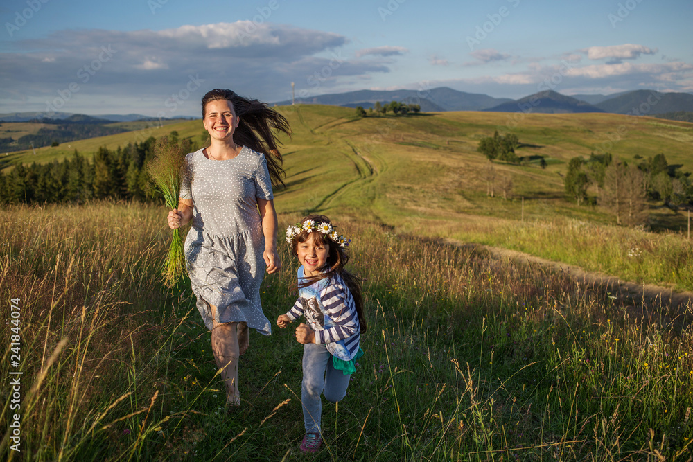  mother and child are having fun in the mountains