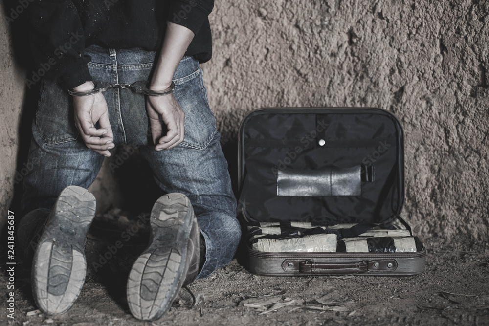 Drug dealer under arrest confined with handcuffs, Law and police