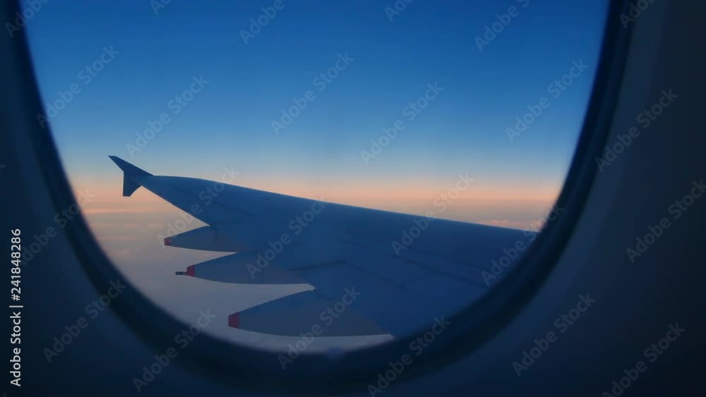 Travel Video View from the Airplane window seat. Twilight view in the early morning reduces speed and landing. Reduce the level of flight to destination with clouds and colorful sky background. Travel Video View from the Airplane window seat. Twilight view in the early morning reduces speed and landing. Reduce the level of flight to destination with clouds and colorful sky background.