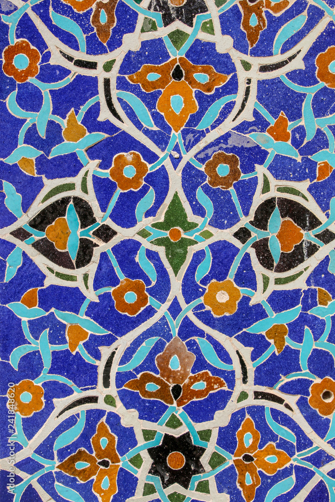 Colorful mosaic and ceramic tiles in the traditional Persian style on the wall of the Jameh Mosque of Isfahan, Iran. Colorful mosaic and ceramic tiles in the traditional Persian style on the wall of the Jameh Mosque of Isfahan, Iran.