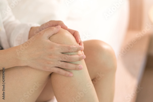 Knee pain disease concept. Woman’s Hands on leg as hurt from Arthritis, gout or infections. photo