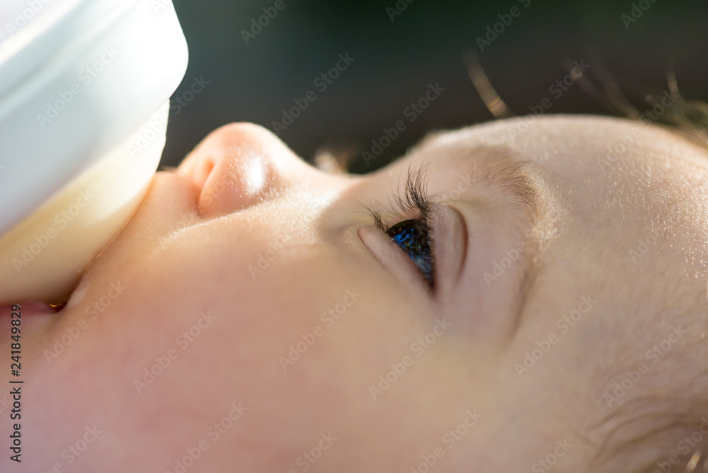 Baby girl drinking milk from a baby bottle Baby girl drinking milk from a baby bottle