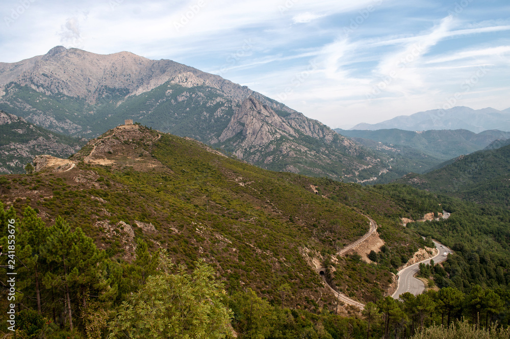 A creepy road leading through the mountainous landscape on the island of Corsica